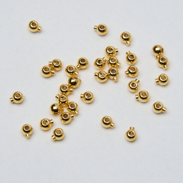 Zacisk w kształcie kulki do nici, linek, sznureczków mosiądz pozłacany 14k Au585 0,8mm
