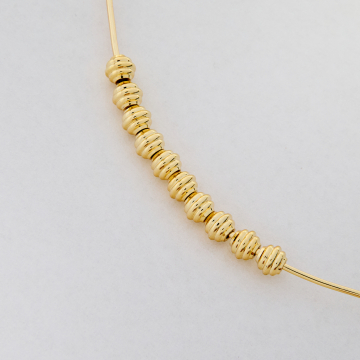 Przekładka kulka nacinana z mosiądzu w kolorze złotym 5x4mm